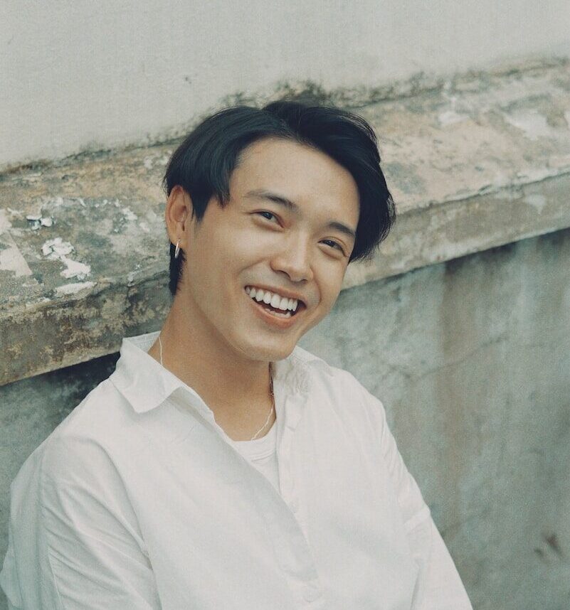 woman in white button up shirt smiling